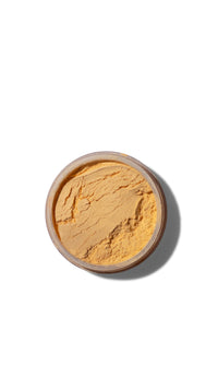 Cosmetic powder in a round container on a white background