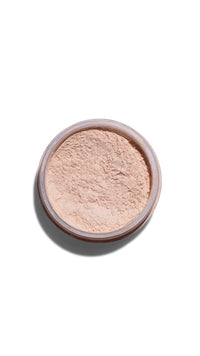 Cosmetic powder in a small round container on a white background